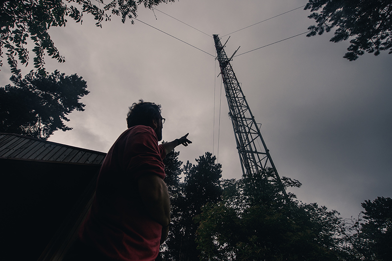 A scientist pointing at the ICOS Saclay Atmosphere station in France.