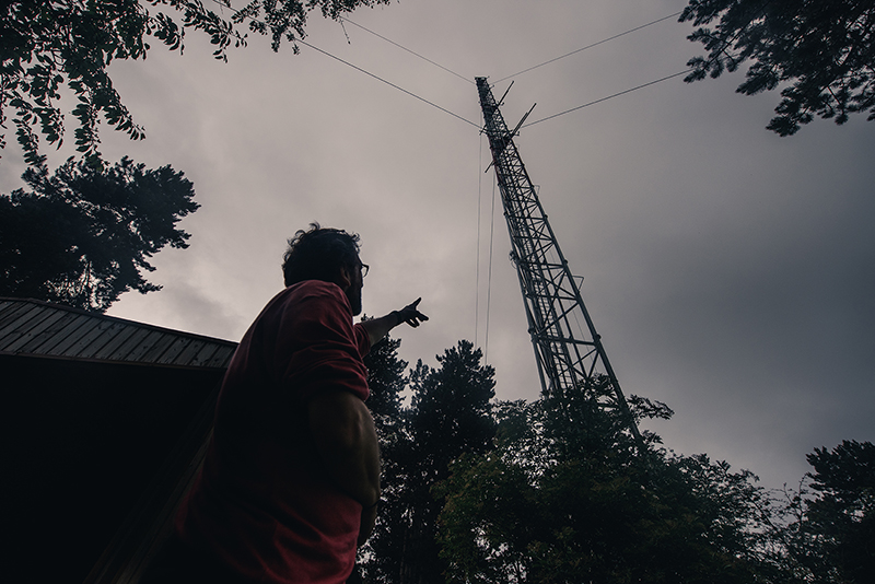 A scientist pointing at the ICOS Saclay Atmosphere station in France. 