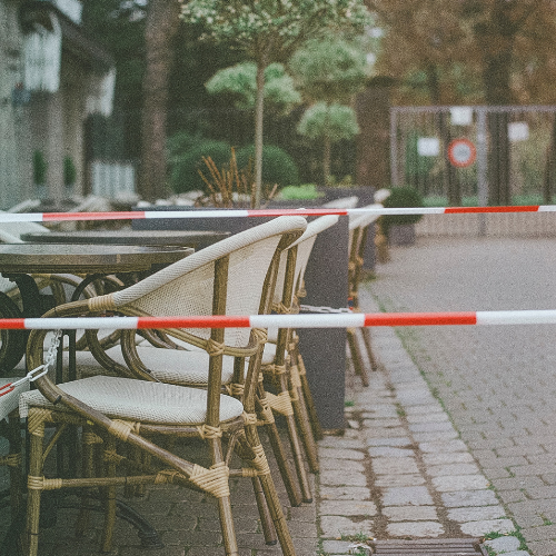 Picture of an outdoor seating area with red tape around it 