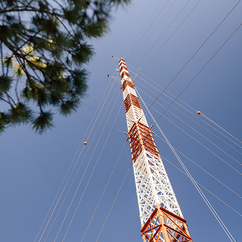 measurement tower from below with blue sky behind it 