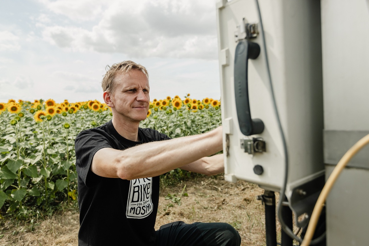 Station PI working on an instrument in the field