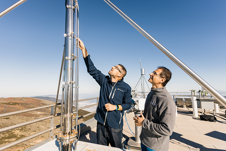 researchers inspecting an equipment at Izana station