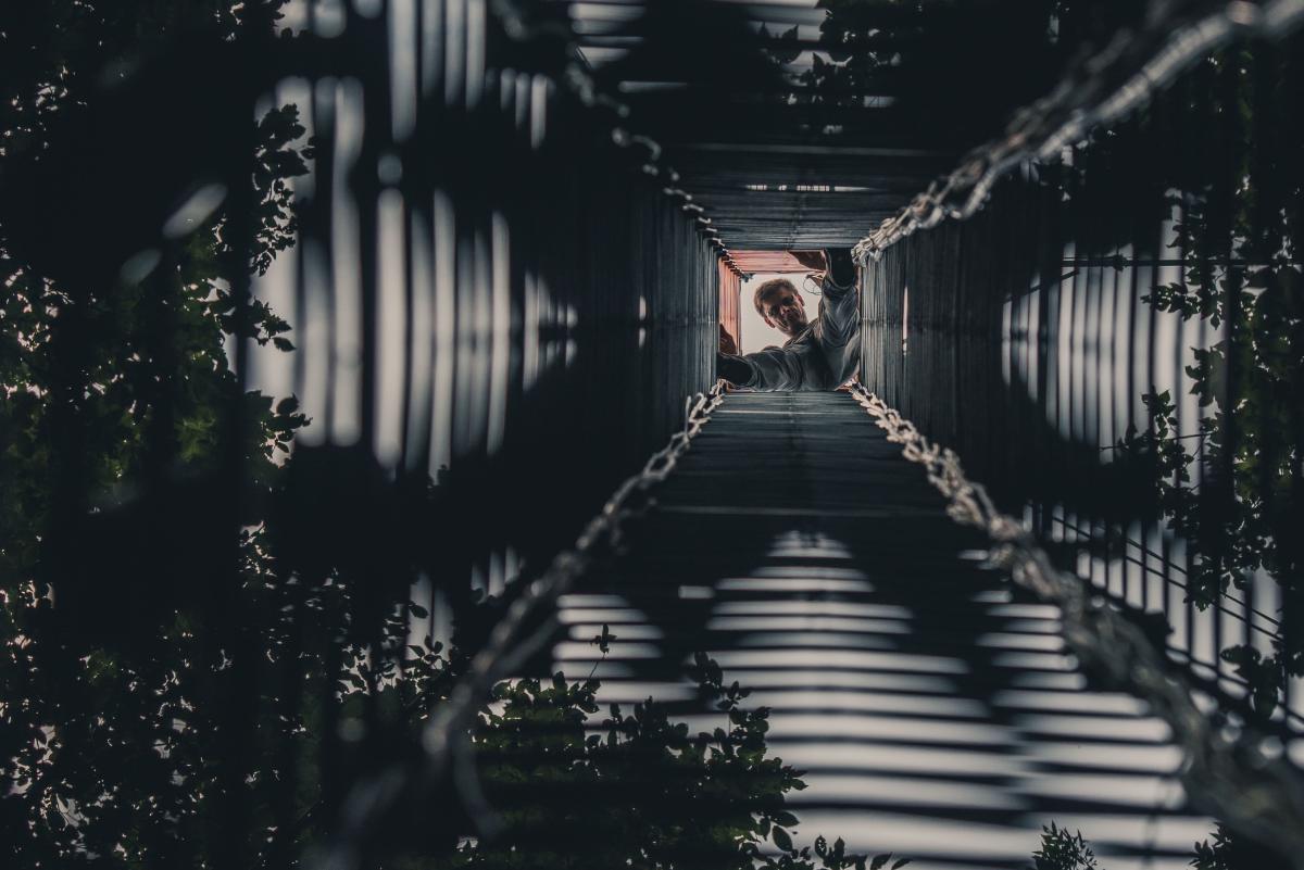 Scientist peering down from the top of Lanzhot tower. Photo by Konsta Punkka