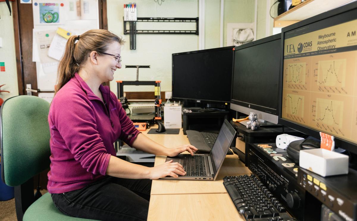 Female researcher sitting on computer inside an ICOS station