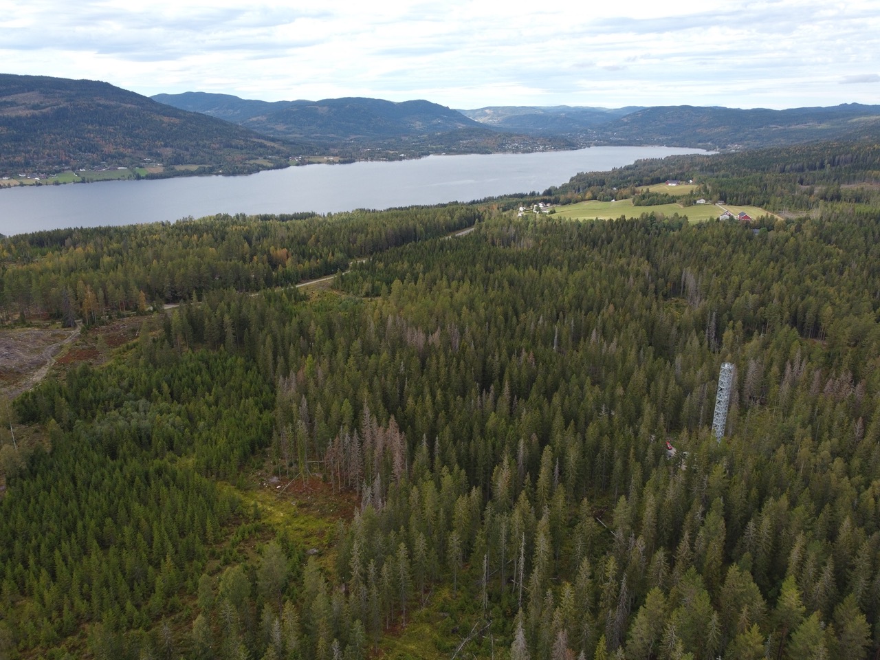 aerial picture of the Hurdal Ecosystem station, located in the middle of the forest with mountains and sea on the background