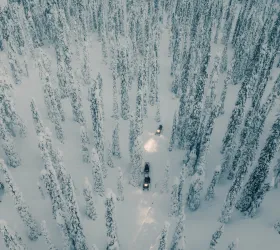 scientists driving snow mobiles in the Finnish Lapland