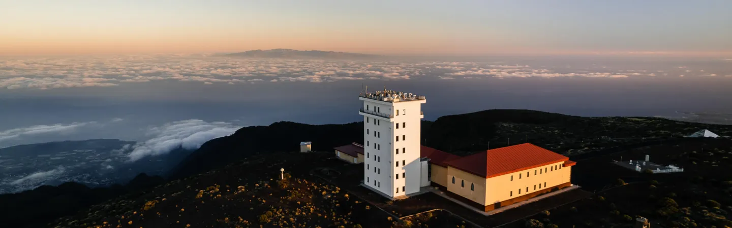 Atmospheric research station above clouds at sunrise