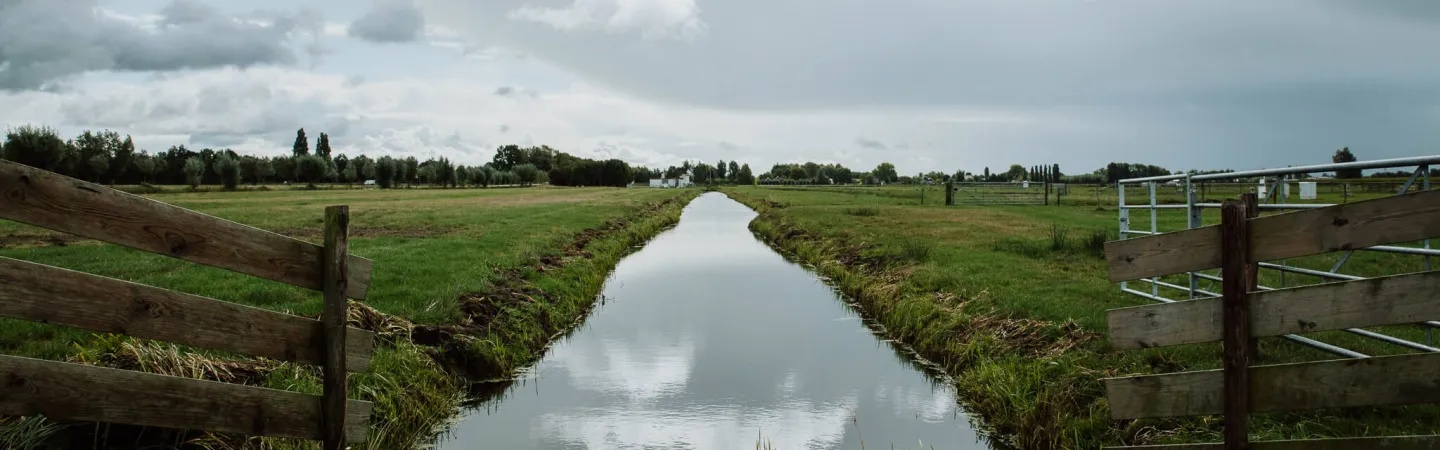 Drainage channel running through open farmland