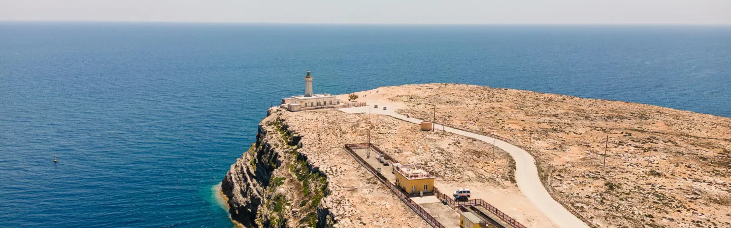 Lighthouse and monitoring station on a rocky coastal cliff overlooking the sea