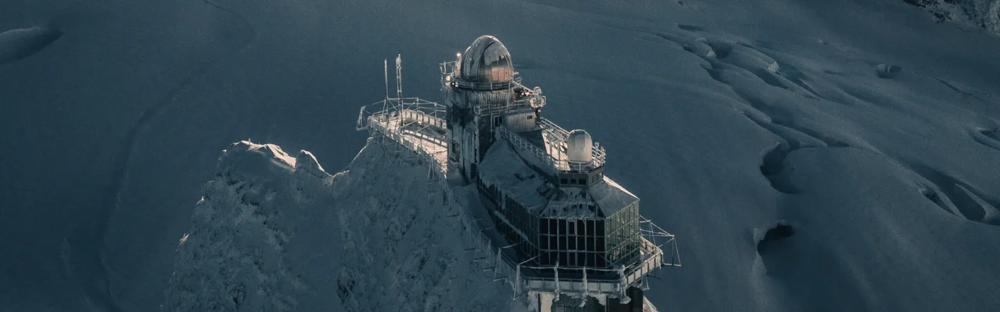 High-altitude research station on a snow-covered mountain ridge