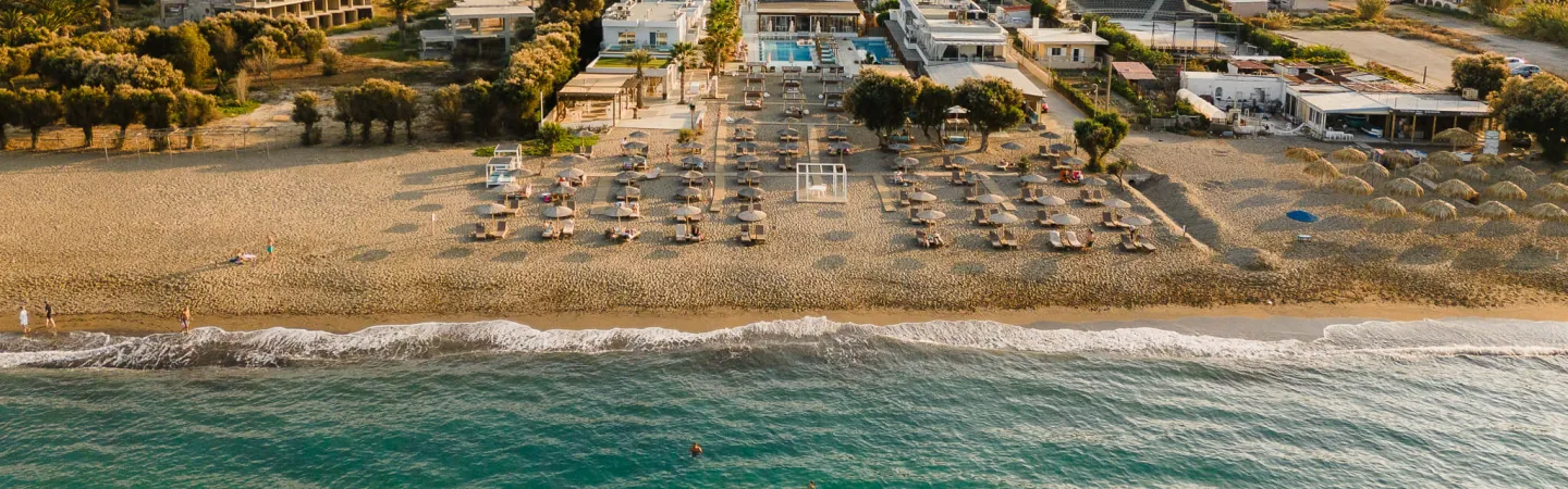 Aerial view of coastal town and beach at sunset