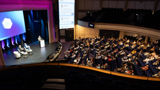 Image of people in a big conference room